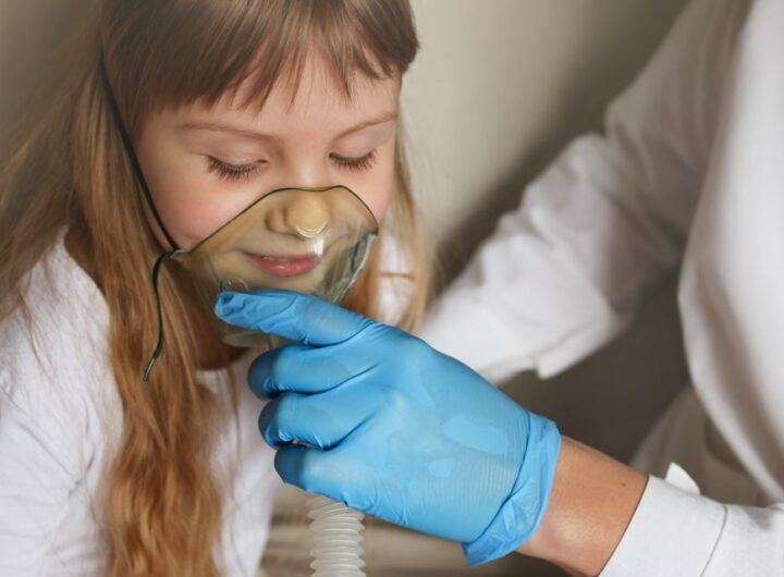 doctor s hand in gloves holds an oxygen mask steam inhaler for a girl asthma treatment breathing through a steam nebulizer