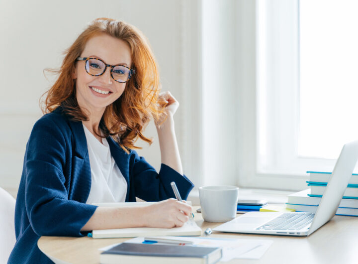 red haired woman analyzes data and makes accounting report1